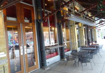 patio-infrared-heaters-hung-from-steel-awning-above-sidewalk
