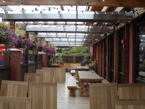 restaurant-patio-heaters-mounted-under-pergola-with-accessory-lighting